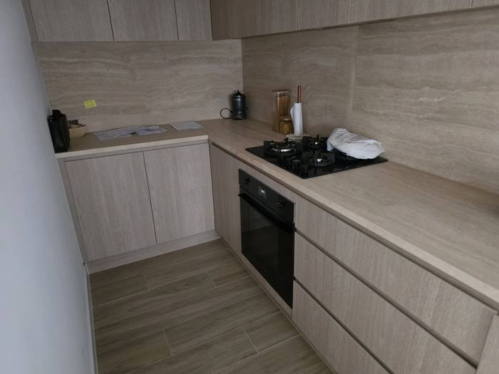 Modern kitchen renovation with stone benchtop and travertine splashback