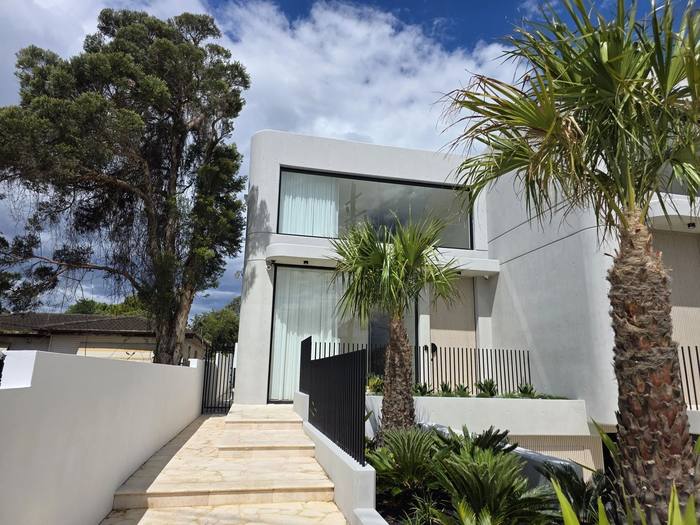 Contemporary architectural home facade with curved concrete render