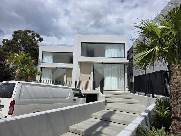 Architectural white render home exterior with palm landscaping
